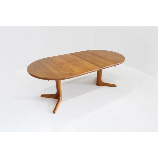 Vintage Danish round extendable dining table from the 1960s made of solid teak wood. This Danish dining table can be...