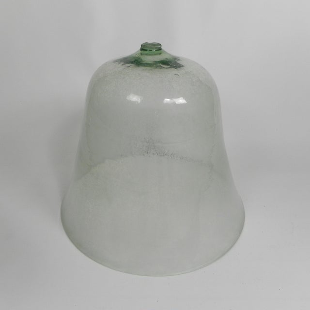 These types of bell jars were used in the (vegetable) garden. The glass makes it work like a kind of mini greenhouse...