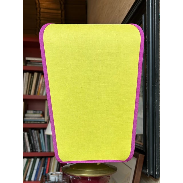 Custom lampshade made in an autumn green linen with plum purple trim along wires. Linen over translucent backing with...