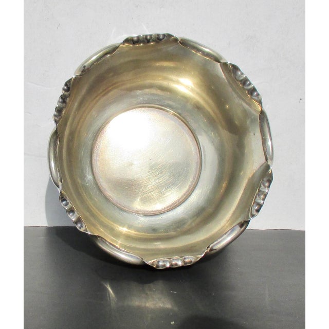 This is a Decorative silver plate bowl with a rolled and scalloped rim. Arts and Crafts design in simple tabletop...