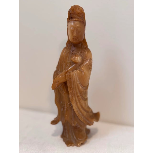 Bring a touch of serenity to your space with this vintage hand-carved Guanyin sculpture. Crafted from warm honey-toned...