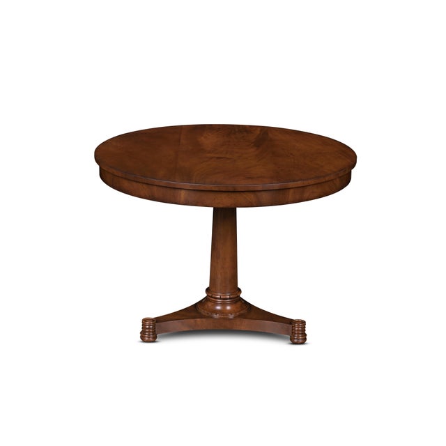 Understated yet impeccably crafted, this round mahogany pedestal table embodies the quiet sophistication of fine...