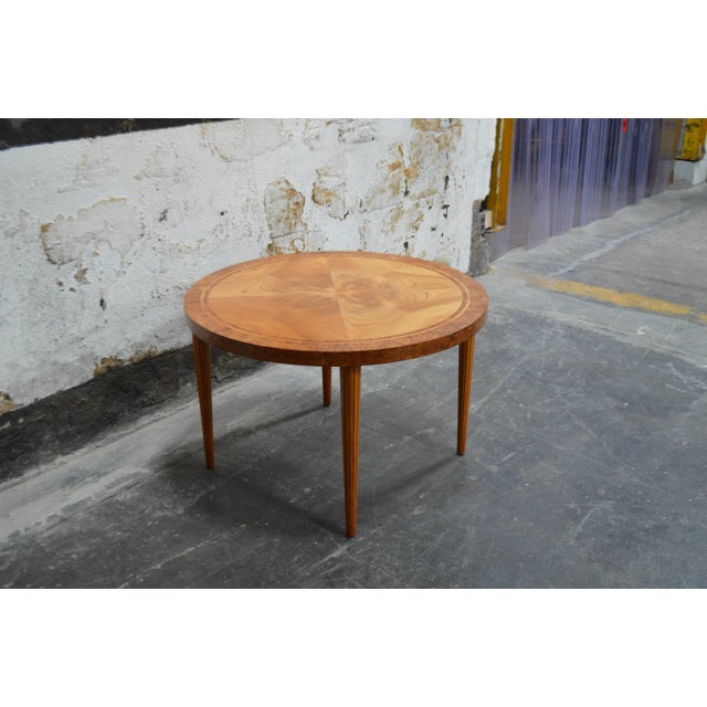 Vintage Swedish Art Moderne round golden elm end or side table. Beautifully detailed with book matched top banded with...