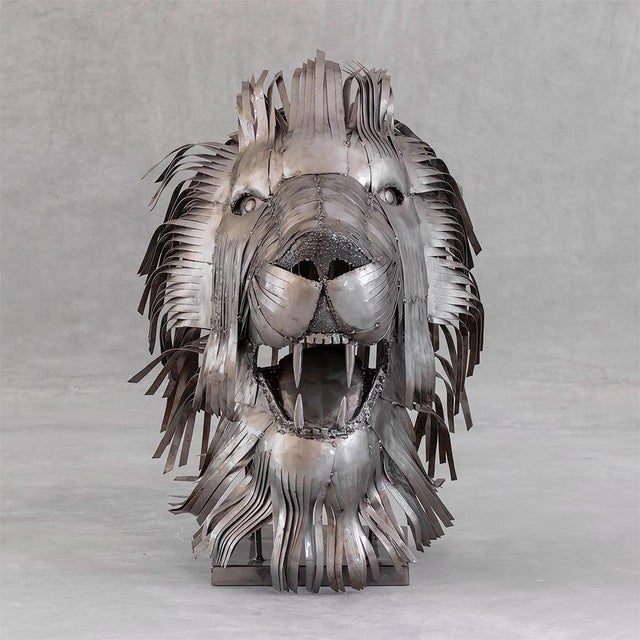 One-of-a-kind contemporary lion head sculpture handcrafted from recycled steel, featuring a powerful frontal composition...