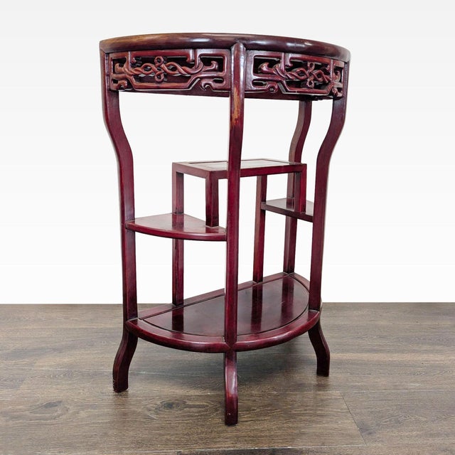 Demilune stand with a carved apron and 3 shelves. Original Price: $500. Dimensions (in): 26W x 13D x 33H.
