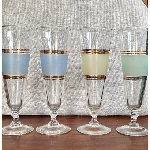 Wonderful set of 4 vintage mid-century pilsner glasses. They feature soft frosted color bands in muted tones (2 blue, 1...