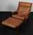 Hans J. Wegner lounge chair and ottoman. Original patinated leather upholstery. Model GE530, made by Getama. This piece is...