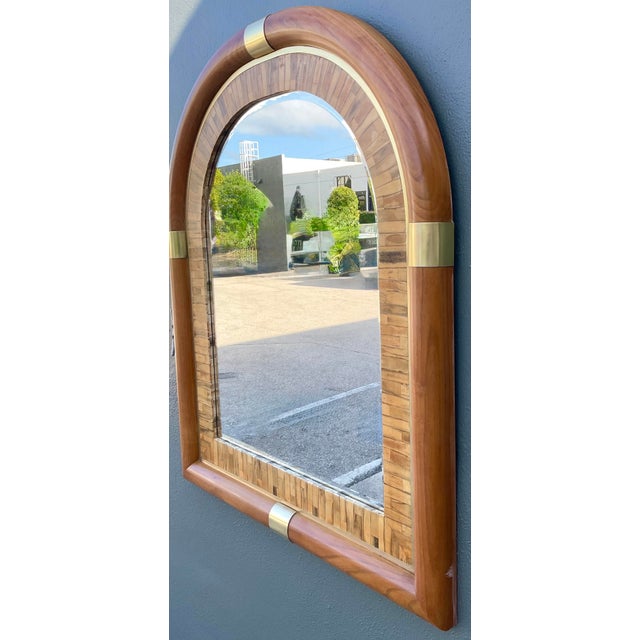 This vintage arched wall mirror is a sophisticated example of late 20th-century architectural design, blending organic...