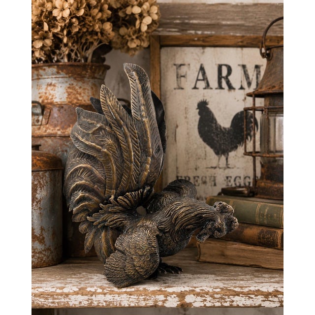 A striking vintage solid brass fighting rooster sculpture featuring dramatic oversized tail feathers, deeply incised...