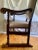 An original antique chair fit for a king. The high back and seat is covered in a light colored leather which should be...
