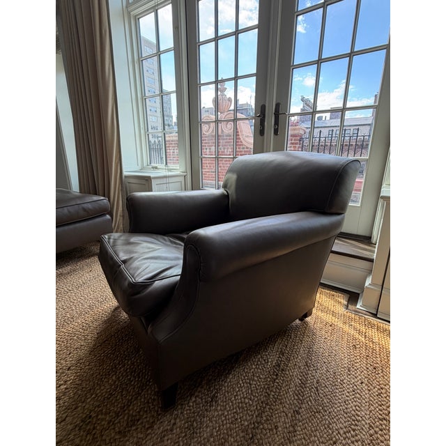 Transitional George Smith grey-brown leather club chair with matching ottoman. Overall - W: 34.5", H: 33", D: 57.5" Chair...