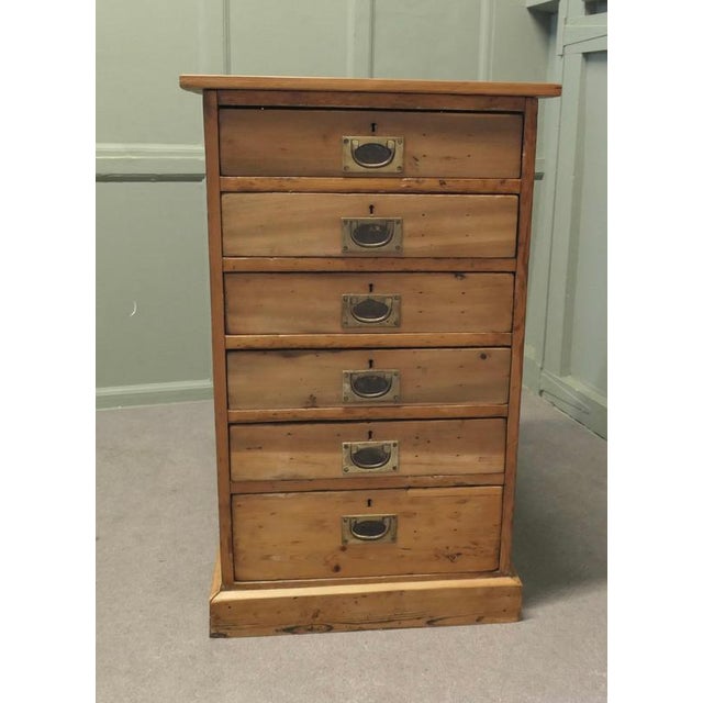 19th Century Shallow Pine Filing Drawers, A Filing Cabinet with 6 shallow Drawers The drawers have campaign style brass...