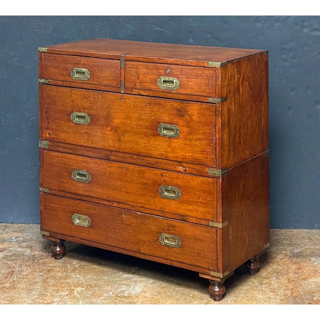 A handsome British military officer’s Campaign Ware chest of drawers or dresser, from the 19th century, featuring a...