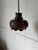 Featuring a bulbous form with decorative circular cutouts along the sides, this hanging light directs illumination...