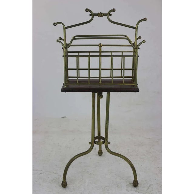 Late 19th century unique edwardian brass, two division revolving magazine holder with central carrying handle, a walnut...