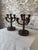 An exceptional pair of antique Eastlake-style wooden candelabras featuring richly carved geometric detailing throughout...