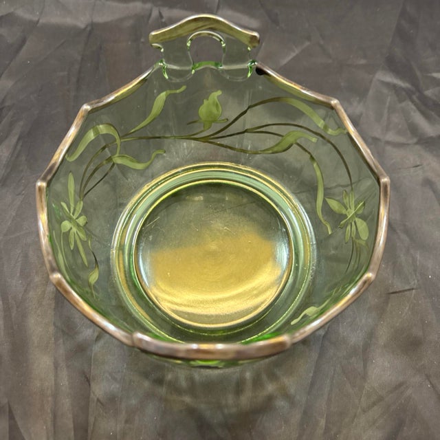 This vintage green uranium glass bonbon candy dish is a rare find with a unique curved bow handle design. Handmade in the...