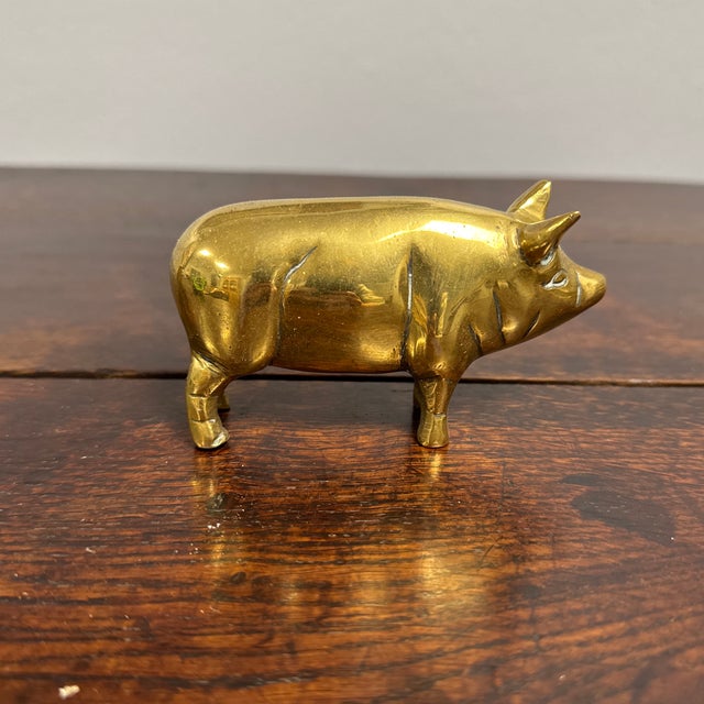 This delightful vintage English brass pig figurine exudes charm with its lovely shiny patina and detailed craftsmanship....