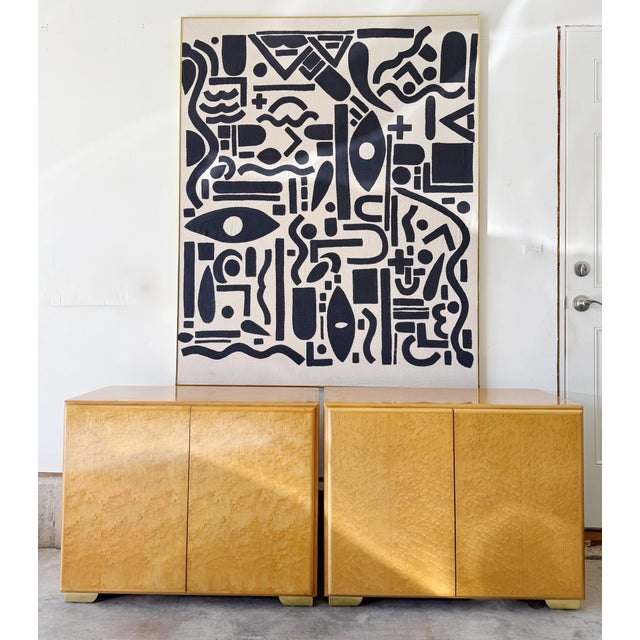 A rare and sculptural duo by Thayer Coggin, wrapped in glowing bird’s-eye maple that catches light like honeyed silk....