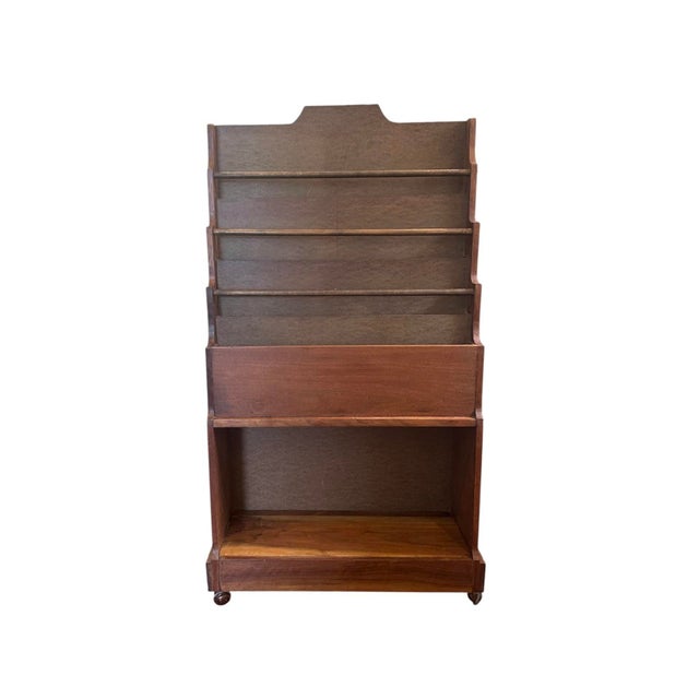A vintage, mid-century wood book shelf. Features a mulit-tiered, wood shelf with racks and shelves to corral books and...