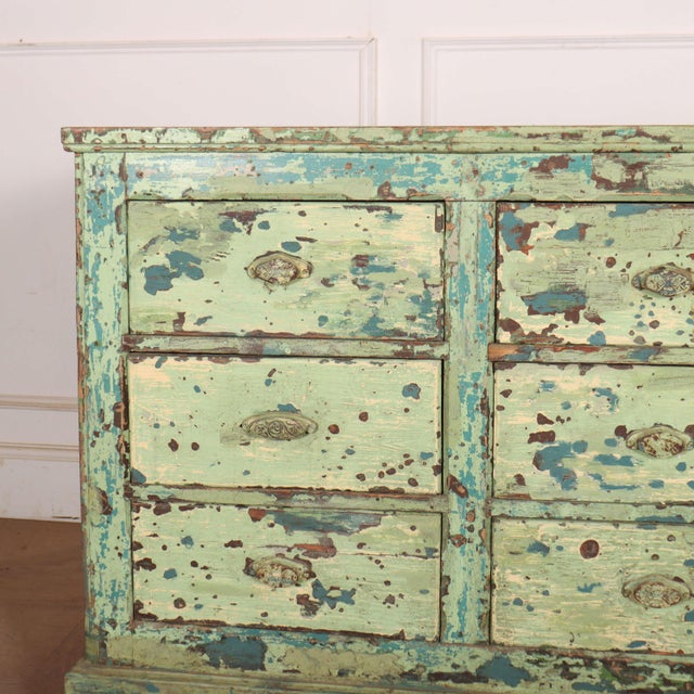 Really funky English nine drawer painted pine dresser base. 1880. This piece is designed in the style of the selected...