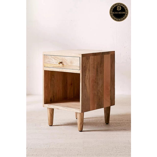 The Solid Mid Century Wooden Nightstand & Bedside Table made in mango wood is a stylish and functional piece of furniture...