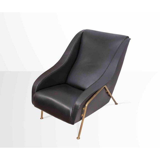 Vintage Leather Armchair is a design item realized in Italy in 1950s. Padded wooden structure. Base with brass tubular....