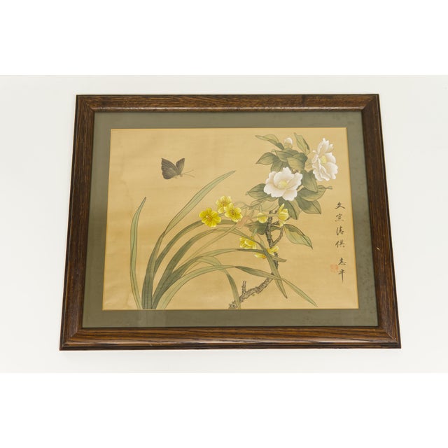 A mid 20th century framed Asian floral print with butterfly and calligraphy.