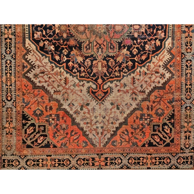 Beautiful Persian Farahan Sarouk area rug in a medallion floral pattern in navy blue, terracotta Red, and camel colors...