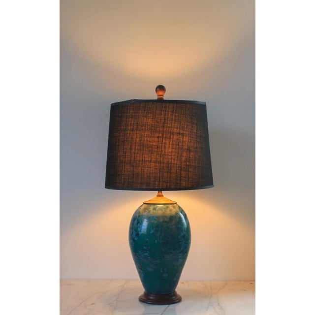 Vintage ceramic table lamp in a beautiful turquoise blue color with wood base. Minor age wear to wood base. No chips or...