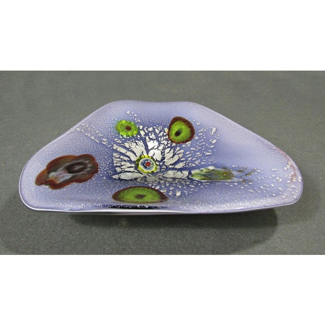 A vibrant Murano Tutti Frutti art glass bowl with a soft lavender-purple ground, white cased underside, silver leaf-style...
