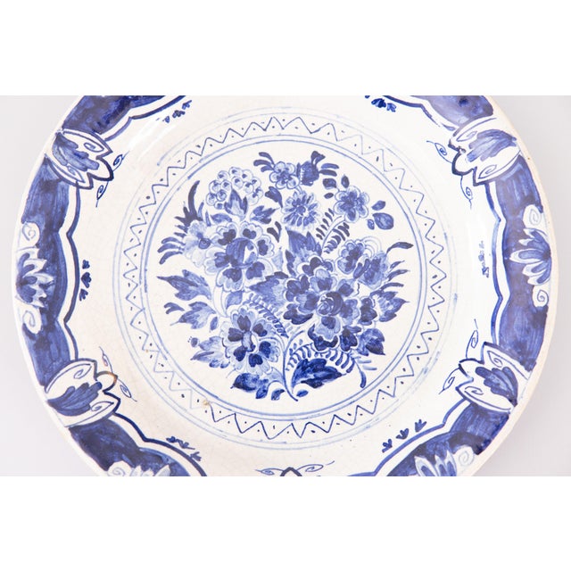 A lovely antique 19th-Century Dutch Delft faience plate by the De Klaauw factory. Maker's mark on reverse. This lovely...