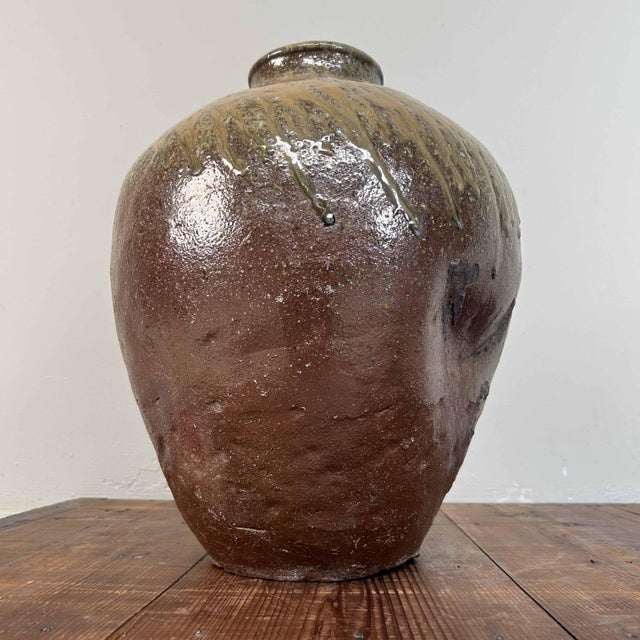 Beautiful Shigaraki pottery tsubo from the 1920s, Japan. Dimensions: height 42 cm, diameter 32 cm. The jar vase features...