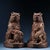 This is a matching pair of cast bronze guardian lion (Foo Dog) figurines, featuring a worn gilt finish over a dark, aged...