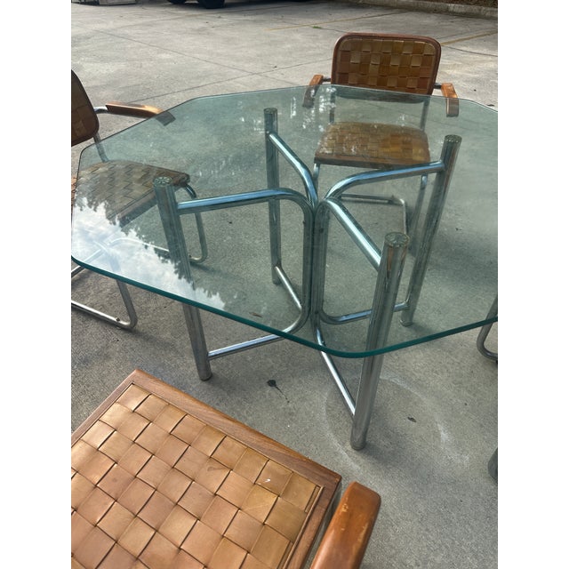 Up for consideration is a beautiful vintage chrome and woven leather dining set with a geometric glass top. This would...