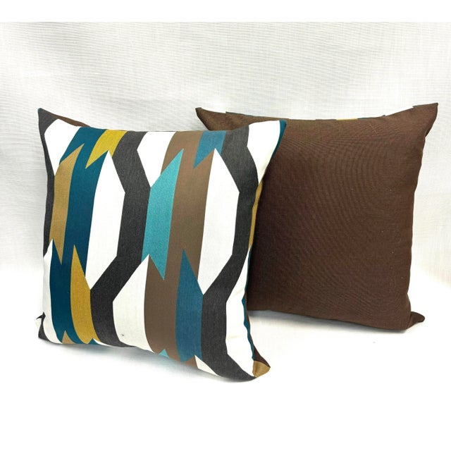 A pair of 19” x 19” pillow covers in Arc Com Crescendo Caribbean fabric (front) and brown Sumbrella (back). Zipper...