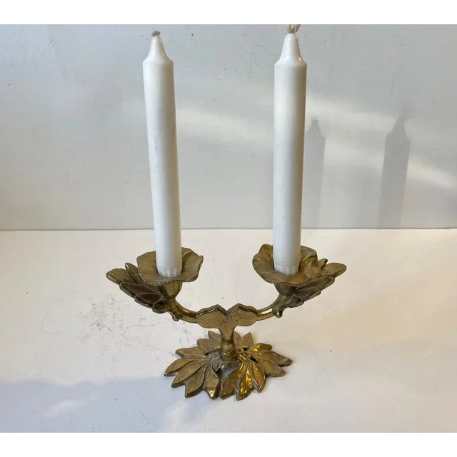 This is a naturalistically shaped candleholder in solid brass. The cast has leaf details. It is made in Italy around...