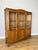 A charming Vintage French Louis bookcase in oak, featuring three glazed front sections, a shaped top profile and elegant...