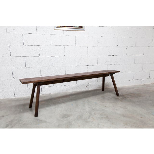 Handcrafted Brutalist bench from the 1960s, made of wood. Solid and stable. Its structure is reinforced by a central beam...