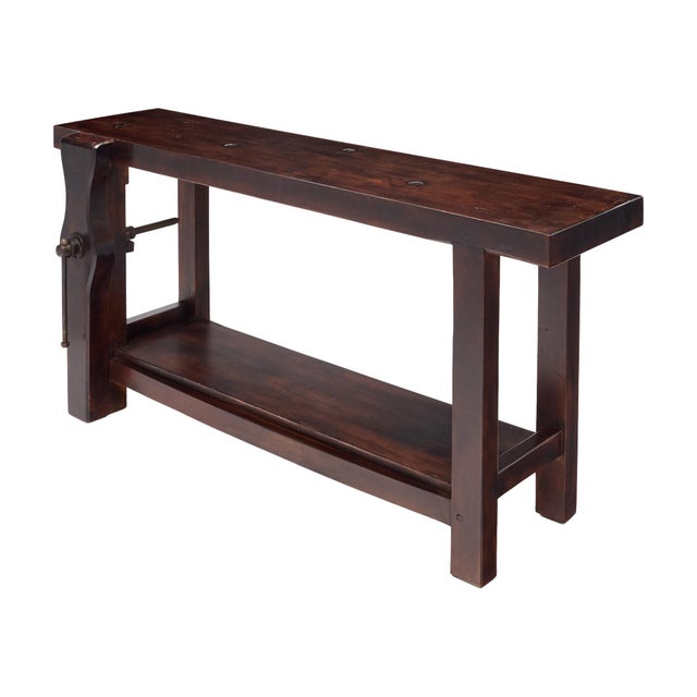 Workbench from the French Alps made of waxed and patinated chestnut wood. The bench features the original vise and clamp...