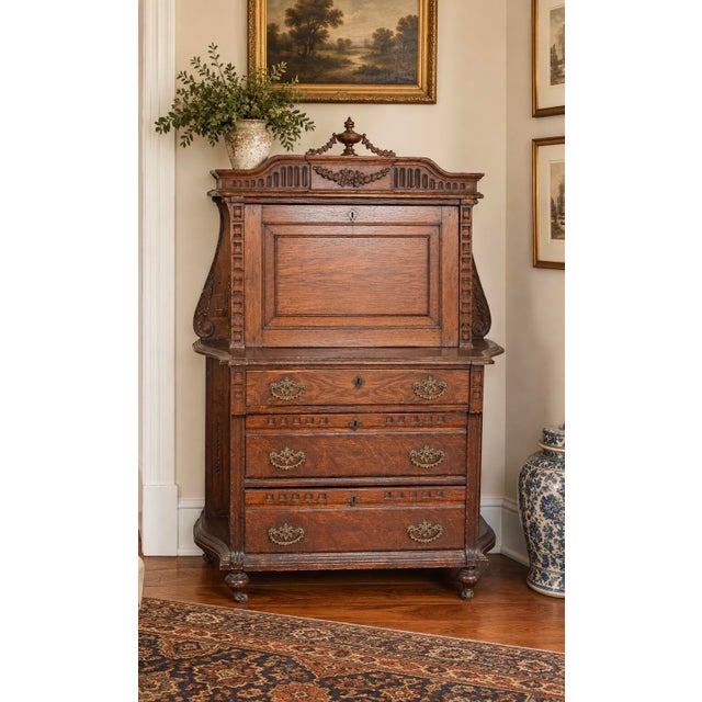 A beautifully detailed late 19th-century Victorian Renaissance Revival drop-front secretary featuring an architectural...