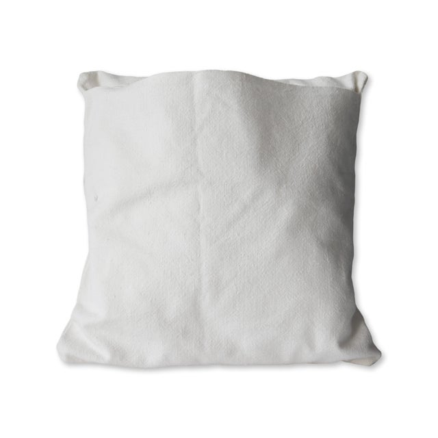 Antique French linen decorative pillow, featuring a beautifully hand-embroidered monogram 'M' on crisp white linen. The...