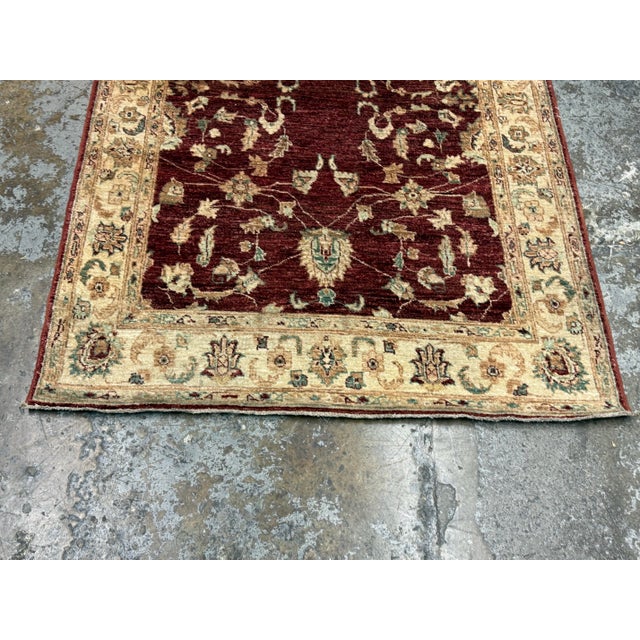 Design Plus Gallery presents a 4ft 2in × 5ft 8in Vintage Pak-Veg Kazaks Hand-Knotted Area Rug. The rug has a burgundy...