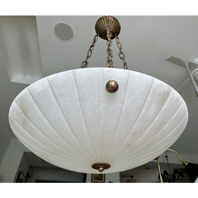An elegant and timeless French pendant light designed in the classical Directoire style, featuring a carved white...