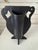 Deliberately off kilter urn vase with brocade textured matte black finish. Quirky fun, with or without flowers.