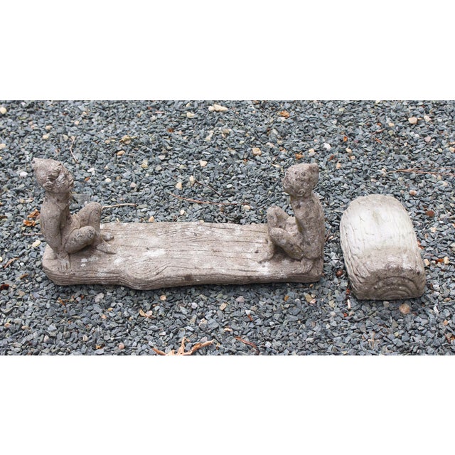 Mid-20th century cast stone elves teeter-totter garden figure, English. Their seat board & base are cast as natural logs....