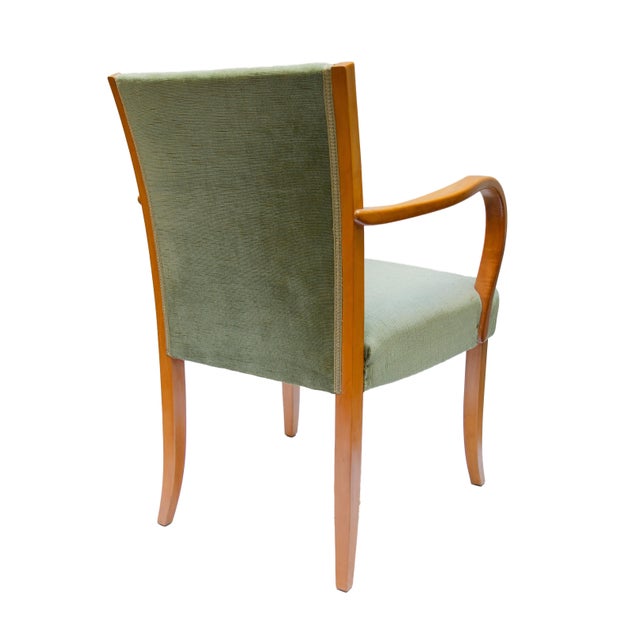 This exceptional set of four armchairs embodies the elegance of the early Mid-Century era at its finest. Architecture,...
