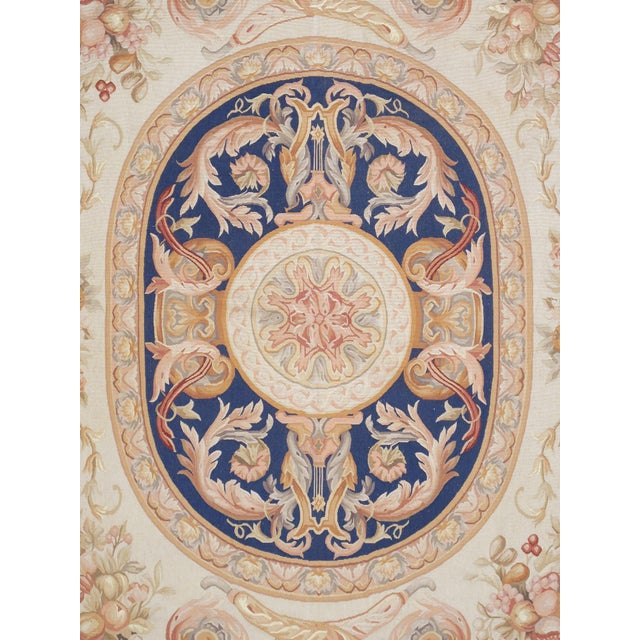 This Aubusson hand-knotted area rug, made from 100% wool, boasts a traditional design in a soothing cream and blue color....