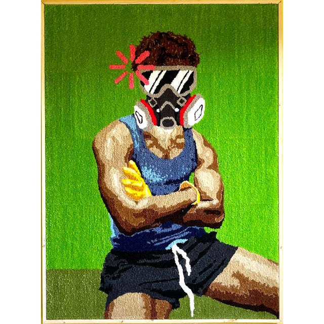 A figure stands with arms crossed, a gas mask in place and a single red flower positioned at the head, all set against a...
