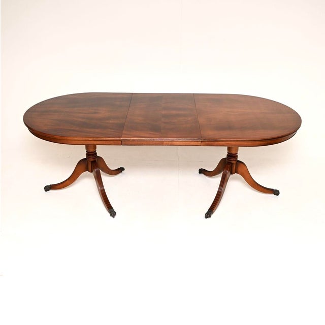 A lovely antique Regency style extending dining table. This was made in England, it dates from around the 1950’s. It has a...